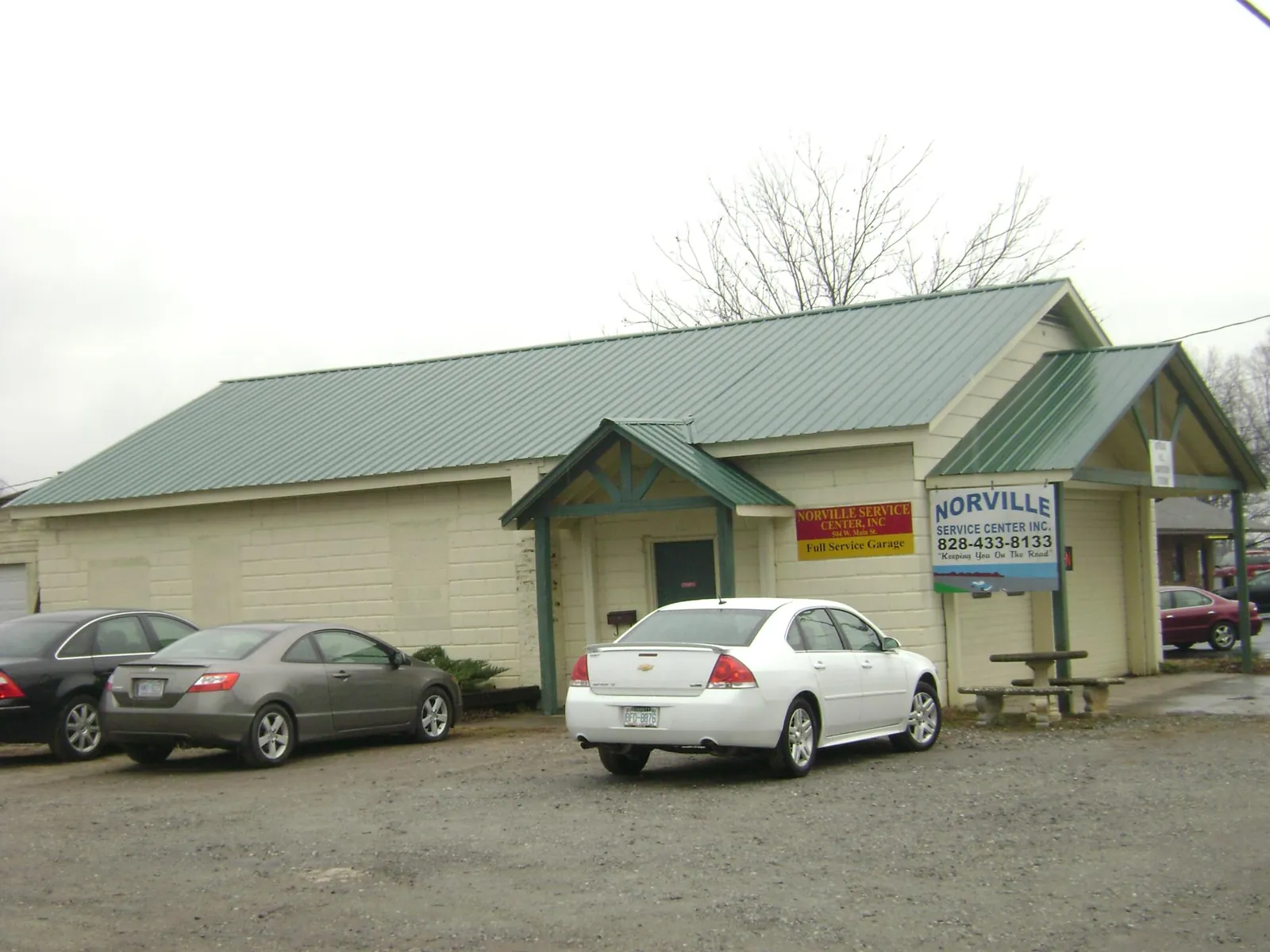 Green metal roof on a service garage with a covered entry in Lesterville